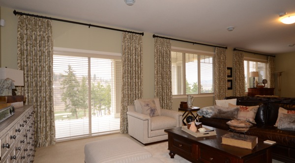 printed drapes framing blinds in living room