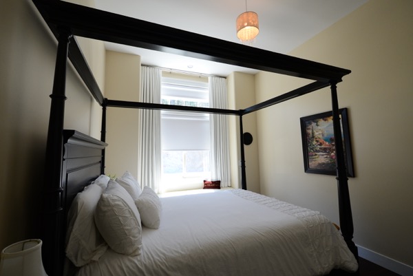 Bedroom with custom drapes in bay window