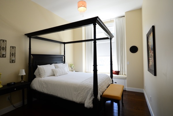 Bedroom with custom drapes in bay window